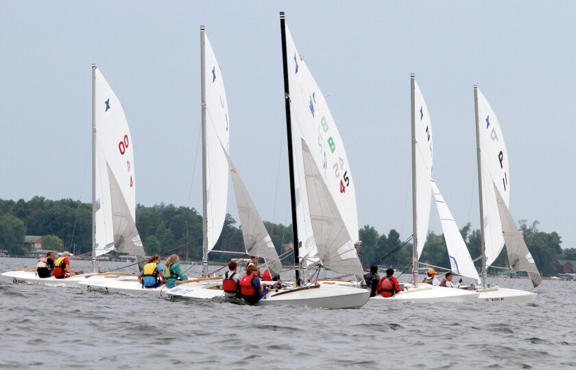 Sail boats race on the lake.