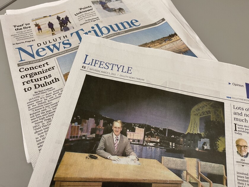 Copy of the Duluth News Tribune with the Lifestyle section pulled out, lead image featuring a blond white man sitting behind a desk.