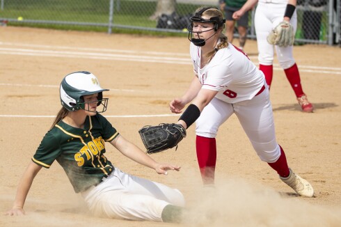 Willmar senior third baseman Marin Enstad attempts to tag out Sauk Rapids senior Chloe Reiter during a Section 8AAA playoff game in Willmar on Tuesday, May 24, 2022.