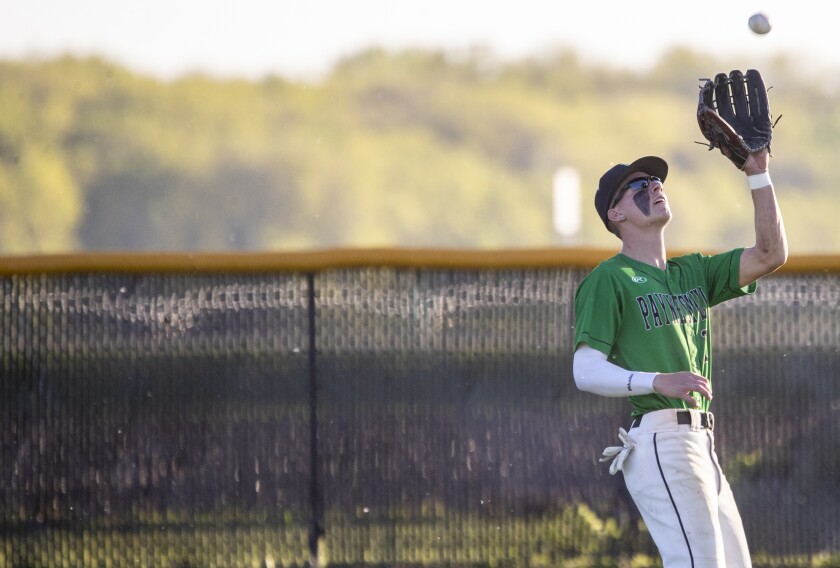 Paynesville outfielder Chase Bayer catches a fly ball as the Bulldogs played host to the KMS Fighting Saints on Thursday, May 26, 2022.