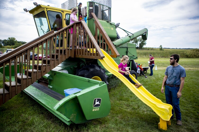 Children play on a harvester converted into a playground during the Atwater Threshing Days on Saturday, September 10, 2022, in Atwater.