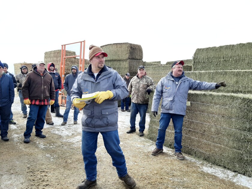 Bid spotters in blue jackets watch the crowd gathered at Mid-American Auction in Sauk Centre, Minnesota, on March 3.