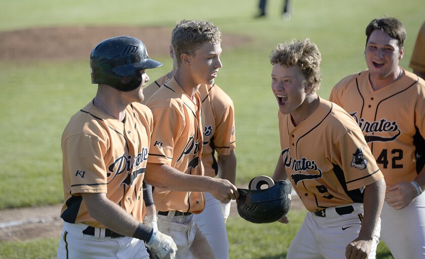 The Paynesville Pirates' Luke Johnson, 9, reacts after Grayson Fuchs, center, ties the game at 7-7 in the bottom of the ninth after stealing home during a Region 4C elimination game against the Willmar Rails on Monday, Aug. 8, 2022 at Green Lake Diamonds in Spicer.