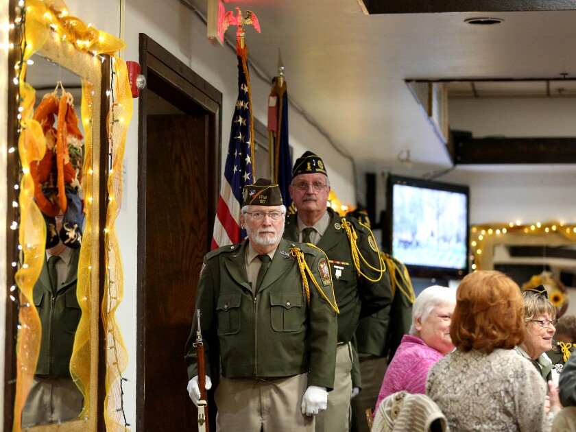 Men with an Honor Guard lined up at a Veterans Day event.