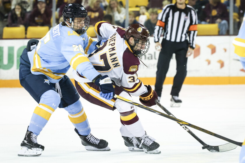 college men play ice hockey indoors