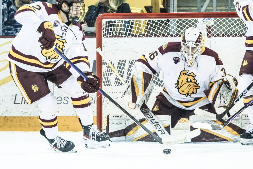 college men play ice hockey
