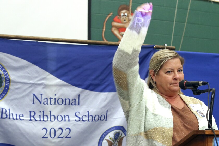 Speaker raises fist in air.