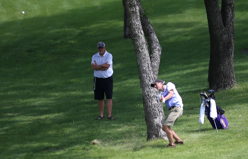 Medalist Justin Nelson of Wahpeton hits an approach shot on the 18th hole during the ND State High School golf championship at the Grand Forks Country Club Tuesday.