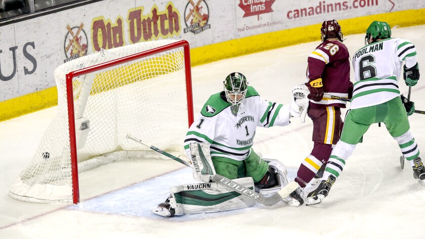 Clint Austin / caustin@duluthnews.comMinnesota Duluth forward Jade Miller (26) watches the puck go into the goal while scoring against North Dakota during Saturday's game at Ralph Engelstad Arena in Grand Forks, N.D.