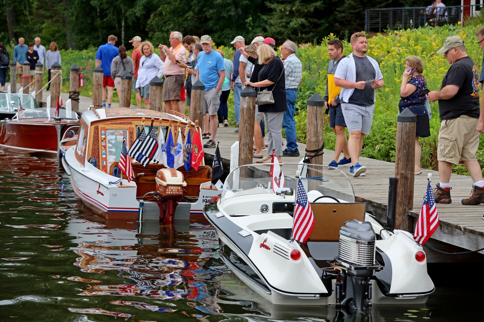 Attendees admire classic boats on display Saturday, Aug. 27, 2022, during the annual Classic Boat Show at the Bar Harbor Supper Club in Lake Shore.