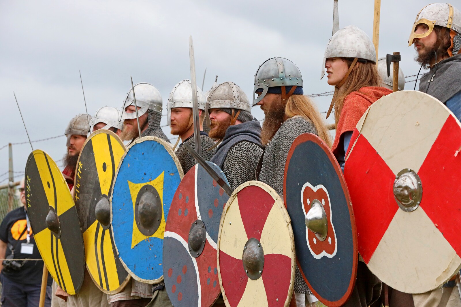 Viking warriors use weapons armor and shields to demonstrate fighting techniques.