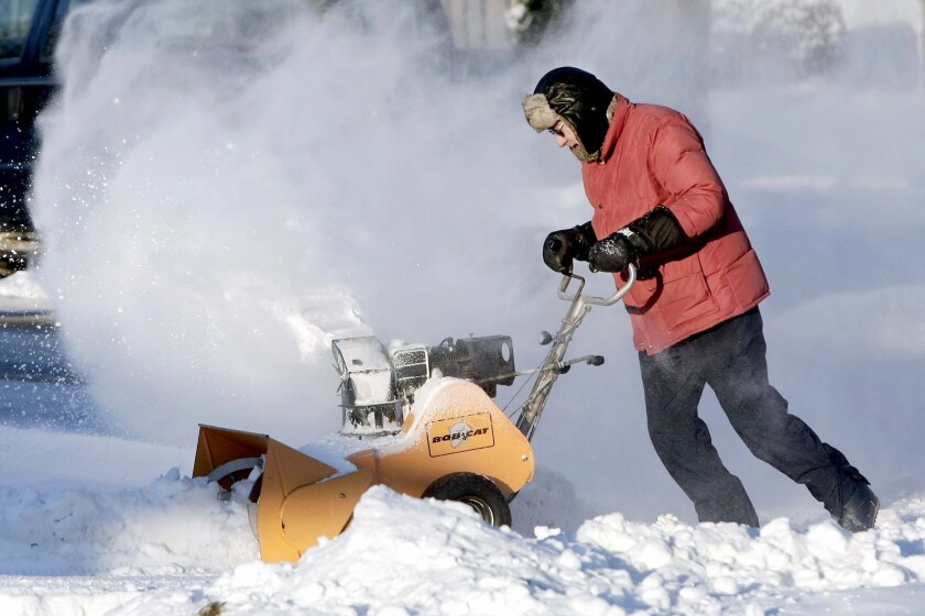 Dennis Unruh snowblows his driveway