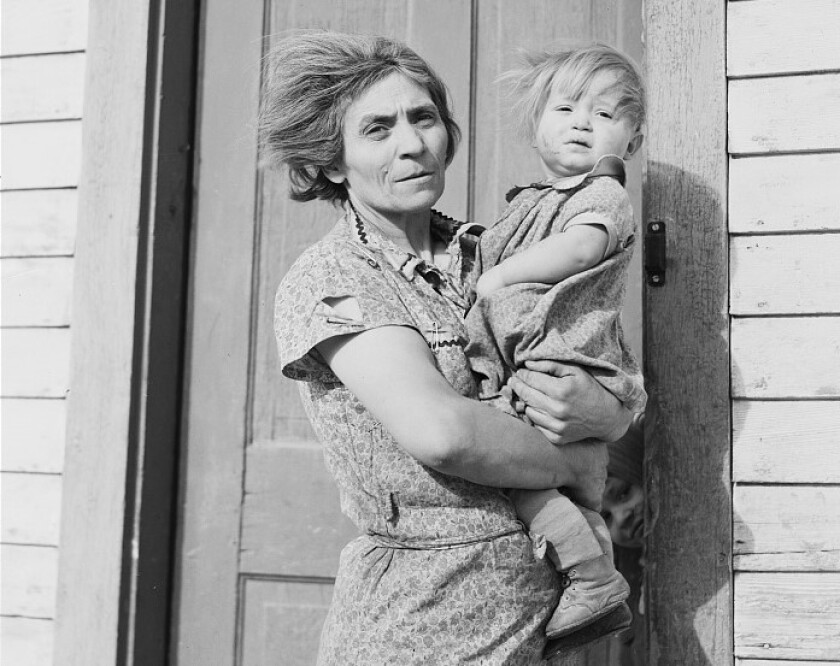 Farmer's wife and baby on steps of farm home in Divide County, North Dakota in 1937 Library of Congress.jpg