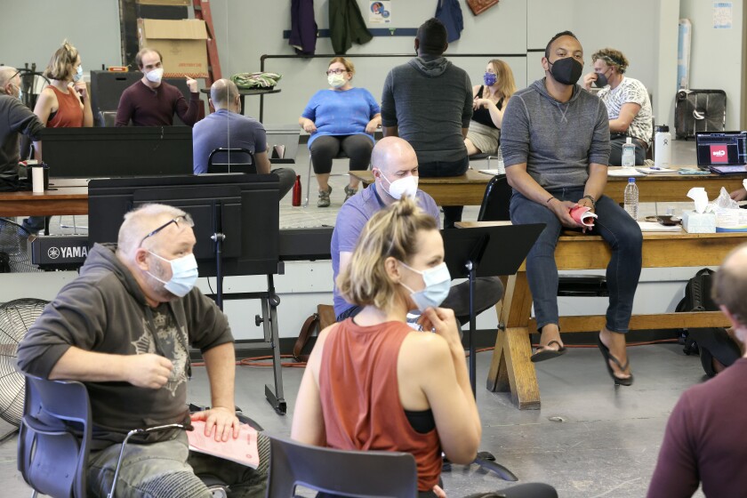 Director listens to actors practicing their lines.