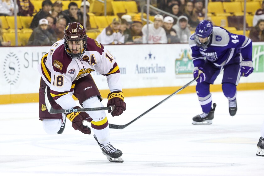 college men play ice hockey