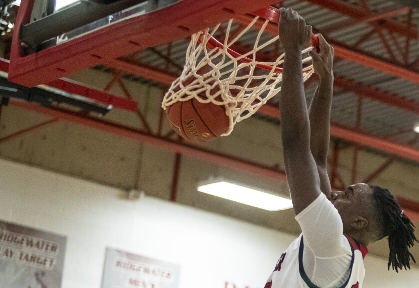 Ridgewater freshman Menelik Garrick dunks the ball while taking on Anoka Ramsey at home in Willmar Feb. 9, 2022.