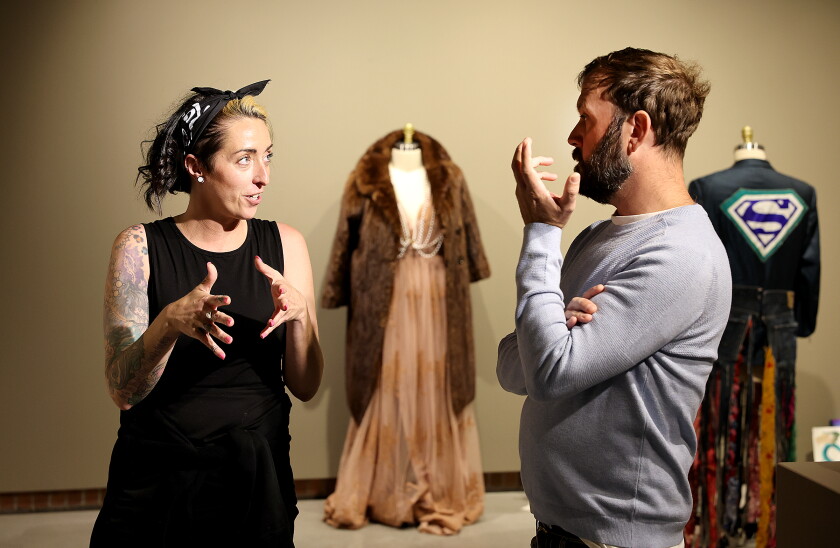 Artist talks to another artist in gallery.