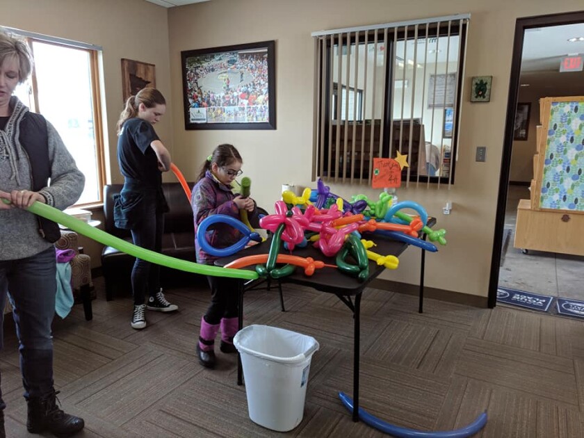 A girl attempts to make an animal out of balloons at a previous Nisswa Winter Jubilee.