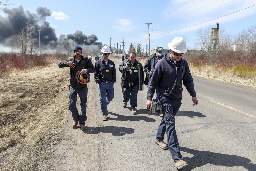 Refinery workers evacuate during a series of fires and explosions at the the Husky Energy oil refinery in Superior, Wis. on April 26, 2018. One of the workers remarked, "I am getting the hell out of here. We are sitting on a bomb that is waiting to go off." --- Clint Austin / caustin@duluthnews.com