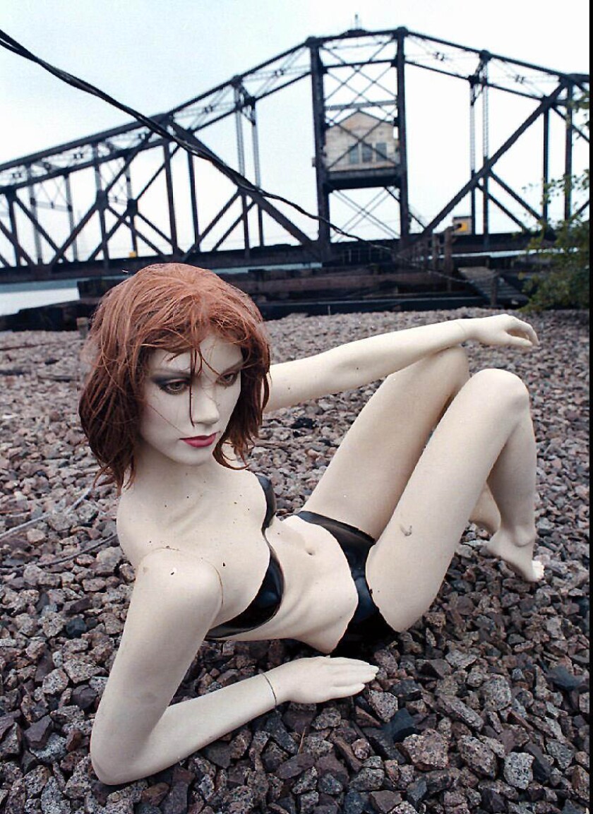 A mannequin lounging on some rocks.