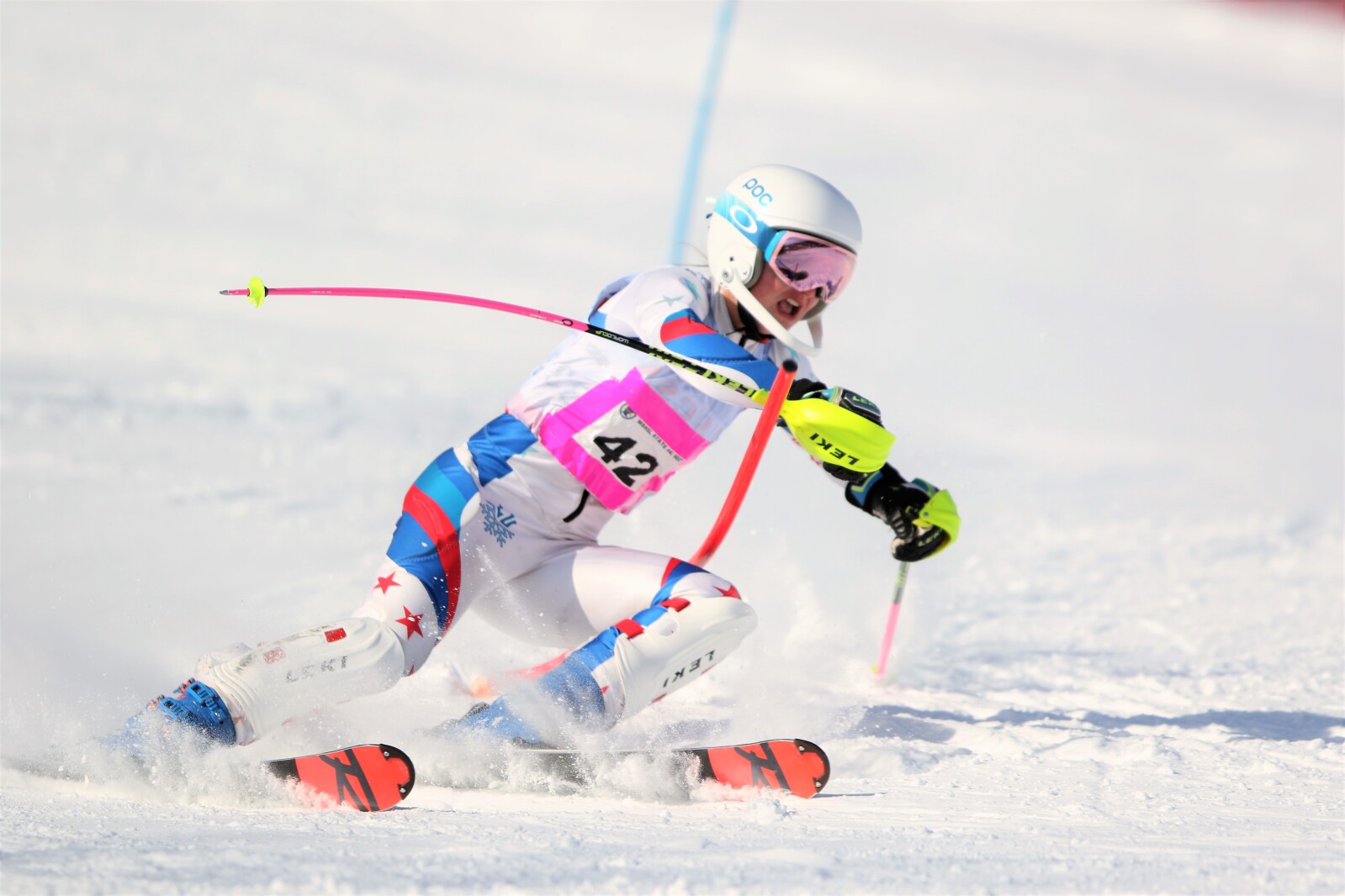 A skier glides down a hillside.