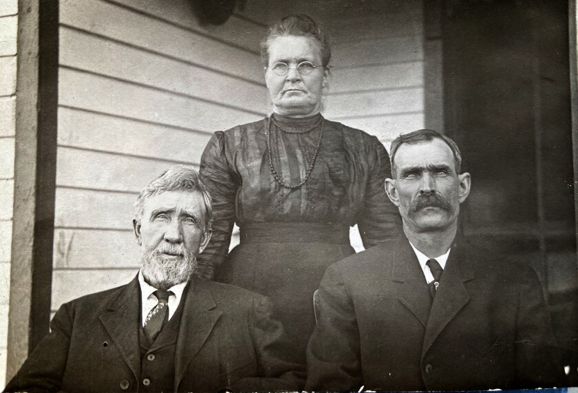 Shown in this photo are Knute Thomas (left), his wife Lena, and neighbor Muns Munson.
