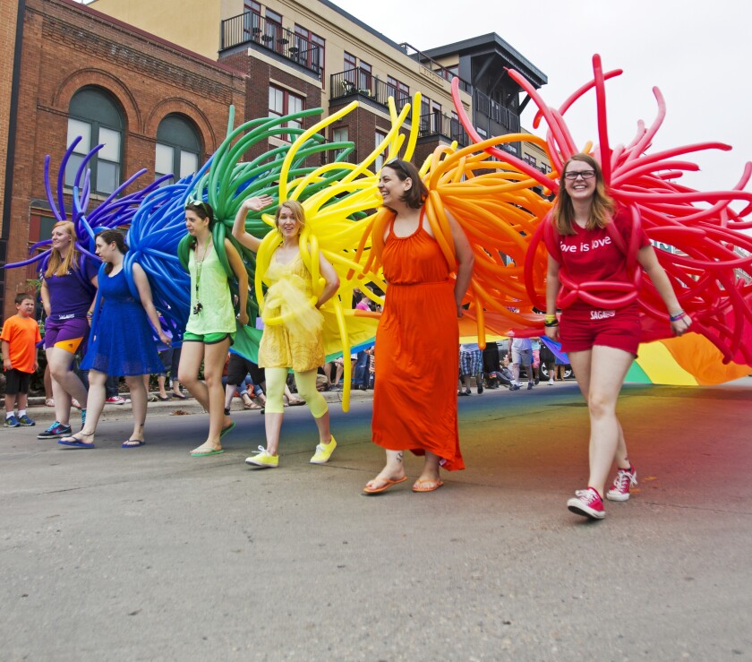 Sara Watson Curry (center), now a Moorhead City Council Member, waves as she marches in the 2014 Fargo-Moorhead Pride Parade. Forum file photo