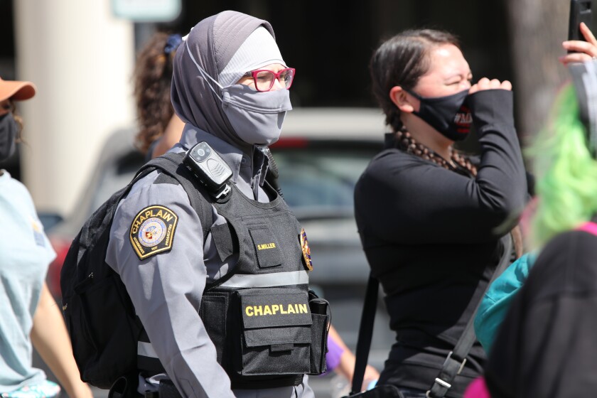 Chaplain Sarah Miller with the Chaplains on Call and Emergency Response Team marches with protesters across First Avenue in downtown Fargo, where the riots occurred on May 30, 2020.jpg