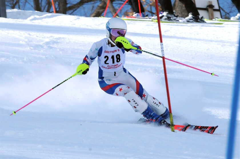 Girl downhill skiing.