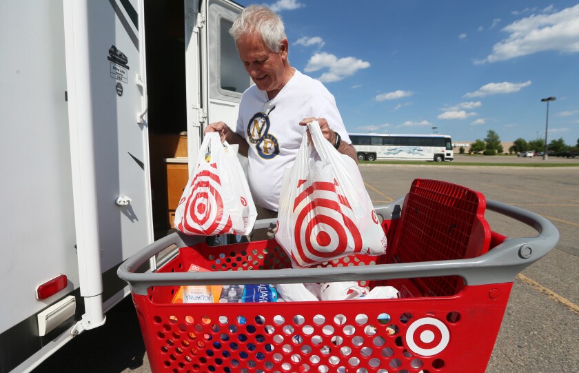 Bill Whitney unloads groceries with his wife, Chris, into their camper at Target in Grand Forks Friday. The Canadian couple stopped to buy groceries on their way to an airshow in Duluth this weekend.photo by Eric Hylden/Grand Forks Herald