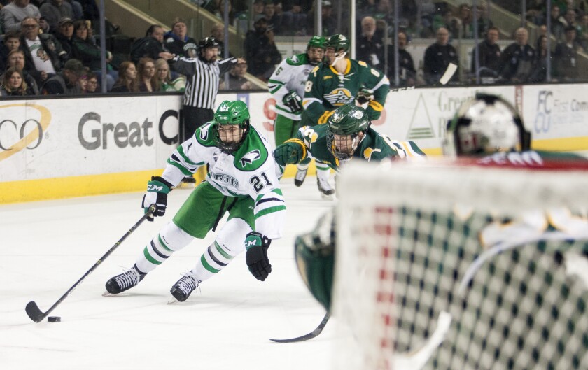 UND forward Jackson Keane drives the puck past Alaska-Anchorage's Jeremiah Luedtke (27). Nick Nelson / Grand Forks Herald