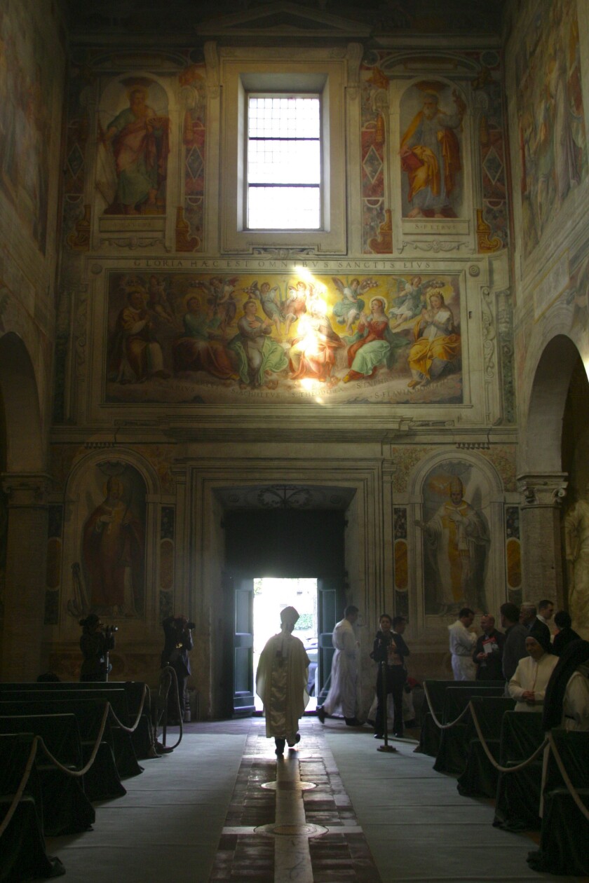 The Rev. McCarrick is assisted in the preparation of incense