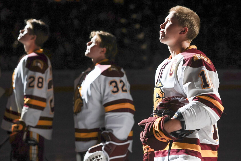 college men play ice hockey indoors