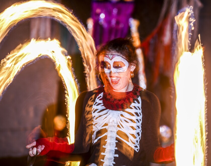 Jillian Forte's face lights up as she spins fire during an All Souls Night performance in Duluth on Nov. 4. Clint Austin / caustin@duluthnews.com