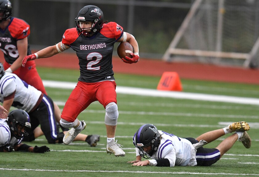 Duluth East’s Austan Orvedahl (2) jumps away from Cloquet’s Warren Hietala (3)