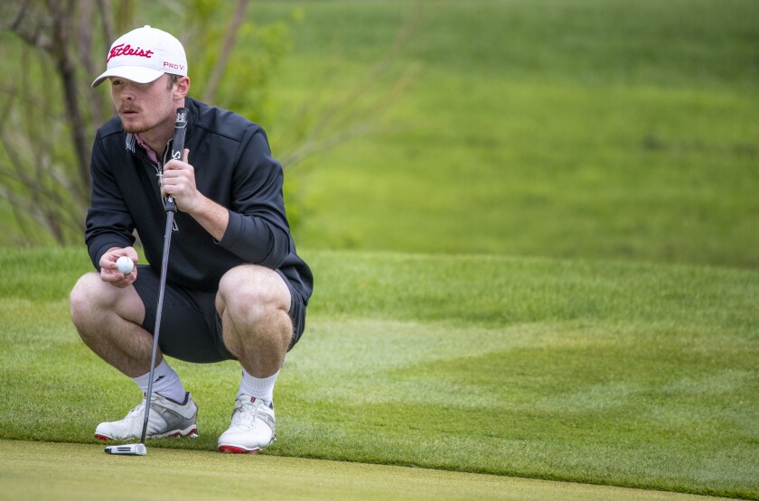 Willmar's Jacob Streed eyes his upcoming putt while competing in the boys varsity conference championship at Eagle Creek Golf Course in Willmar on Friday, May 20, 2022.
