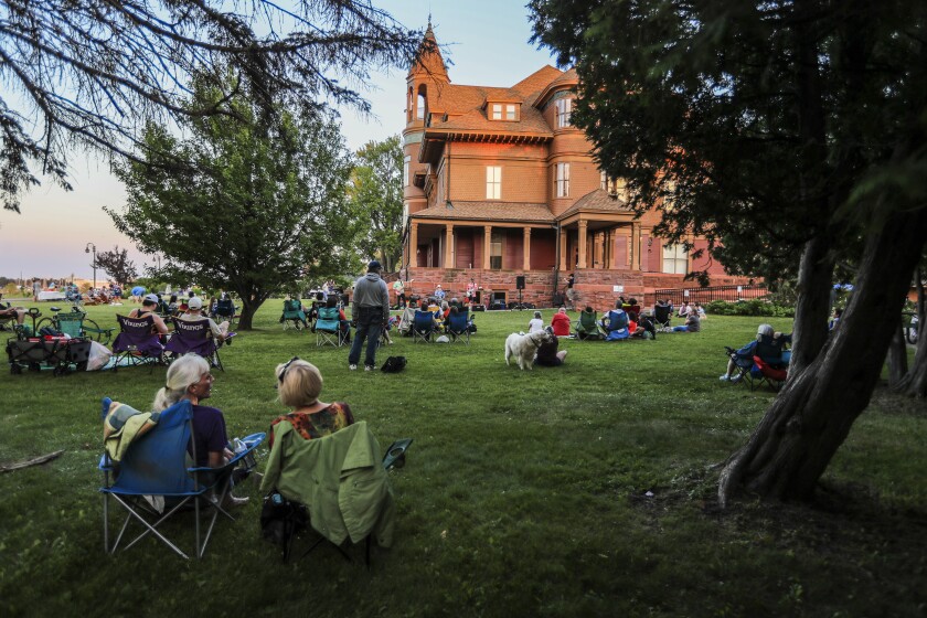 People outdoors at historic mansion