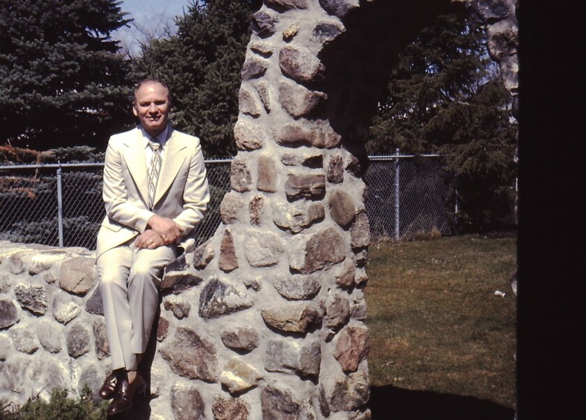 Virgil Hilborn atop the arched fence he made by hand..jpg