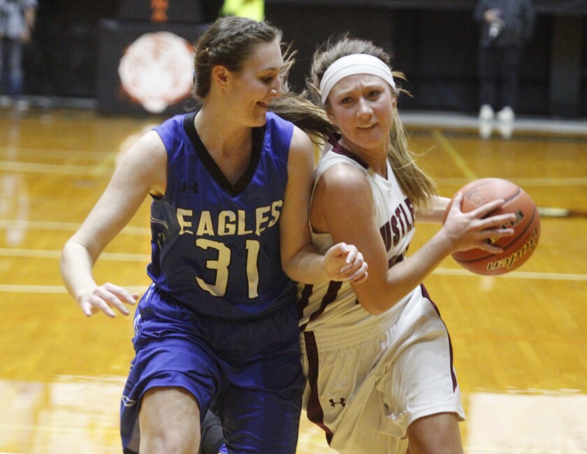 Ethan's Rachel Hawkins, right, drives to the basket as Irene-Wakonda's Taylor Lee, left, tries to defend her during a first round Class B state girls basketball tournament game on Thursday at the Huron Arena in Huron. (Eric Mayer/Republic)