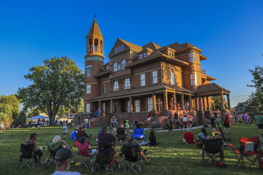 People outdoors at historic mansion