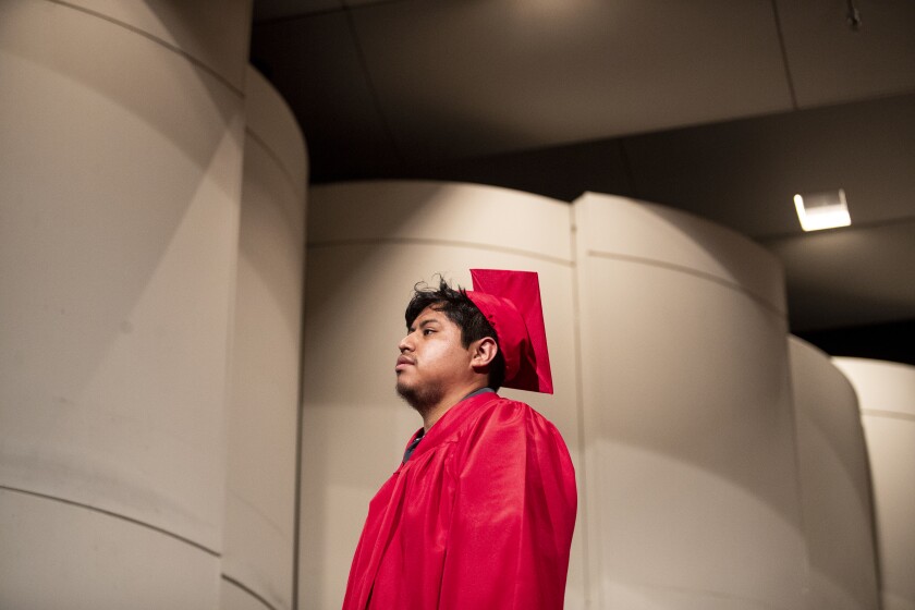 Brandon Paxtor walks across the stage during the Area Learning Center's senior graduation ceremony on Thursday, May 19, 2022, at the Willmar Education & Arts Center.