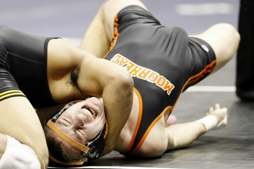Skyler Berry of Moorhead wrestles David Johnson of Apple Valley