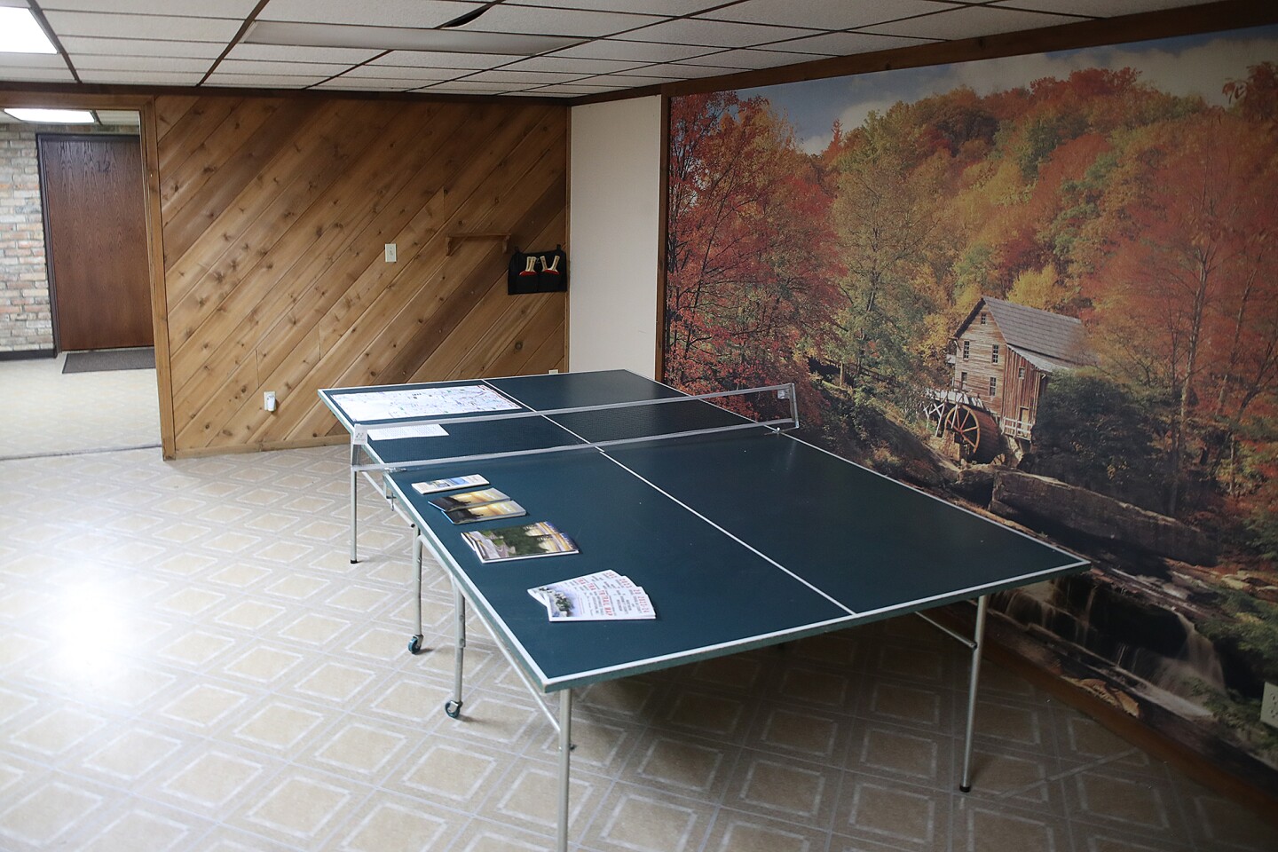 Ping pong table sits in room.