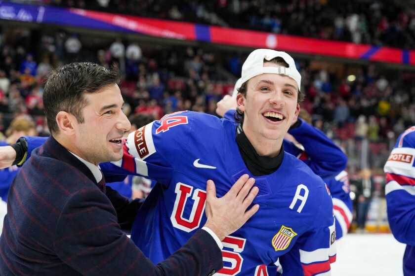 Team USA assistant coach Garrett Raboin and alternate captain Gabe Perreault celebrate after defeating Finland 4-3 in overtime in the gold-medal game at the IIHF World Junior Championship on Sunday, Jan. 5, 2025, at Canadian Tire Centre in Ottawa, Canada.