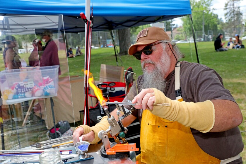 Mark Cross does glass lampwork while at Arts in the Park on Sunday, June 26, 2022, at Gregory Park in Brainerd.