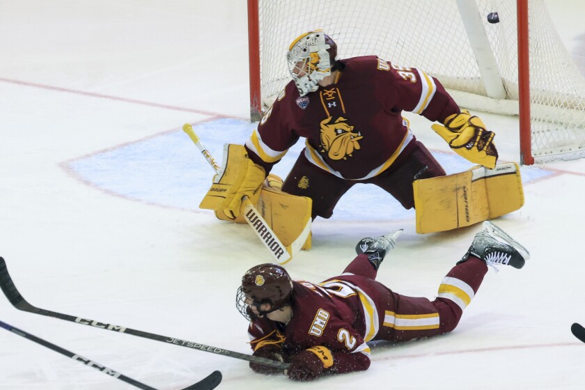 college men play ice hockey