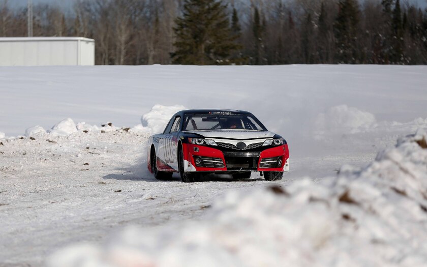 A retired NASCAR Cup Series car regaining control on a track.