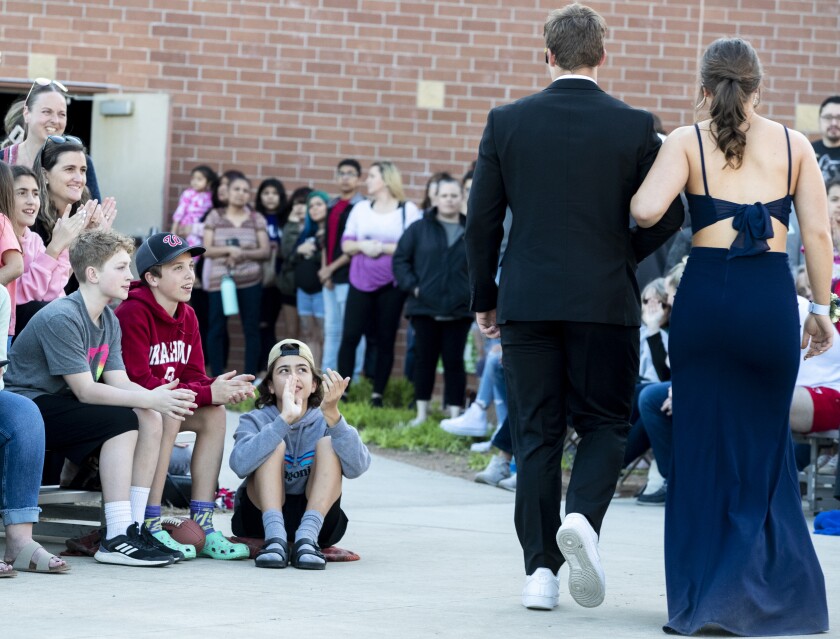 Attendees applaud couples as they pass by and walk into Willmar High School during prom Friday, May 6, 2022.