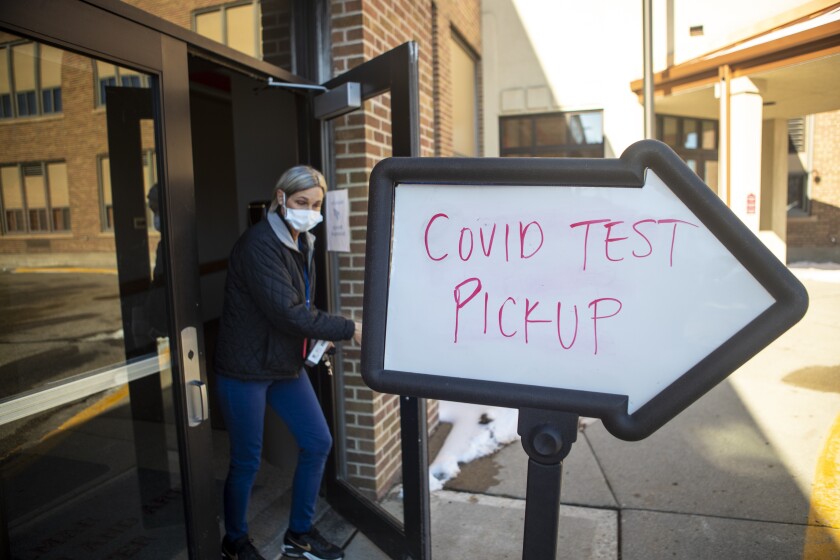 A person departs the Willmar Education & Arts Center Thursday, Jan. 27, 2022, where free COVID-19 testing kits were being given out