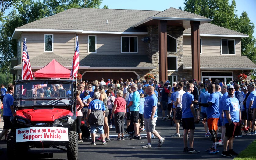 People gathered in front of a house for a race